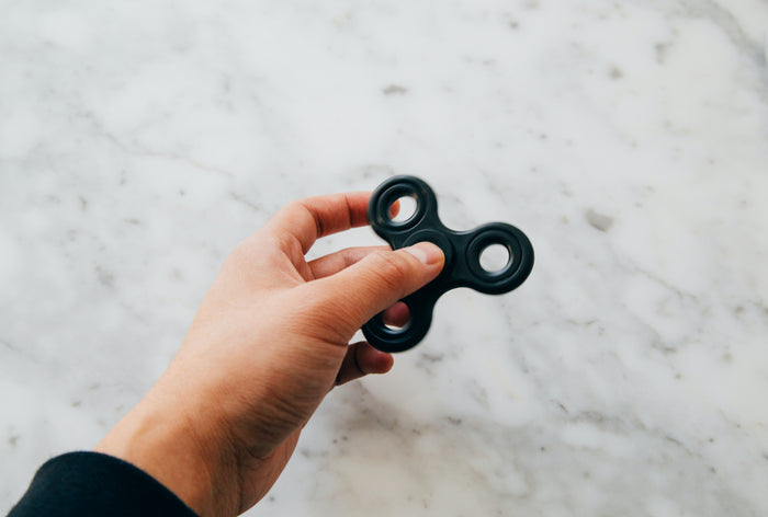 Hand wearing a spinner ring as a stylish fidget spinner alternative for calm and focus