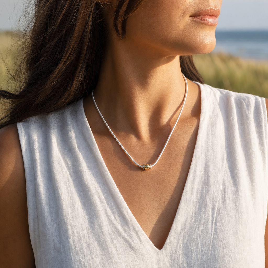 Coastal Ball Necklace in Sterling Silver with 14k Gold Filled Ball, worn by a model, Ideaure photo