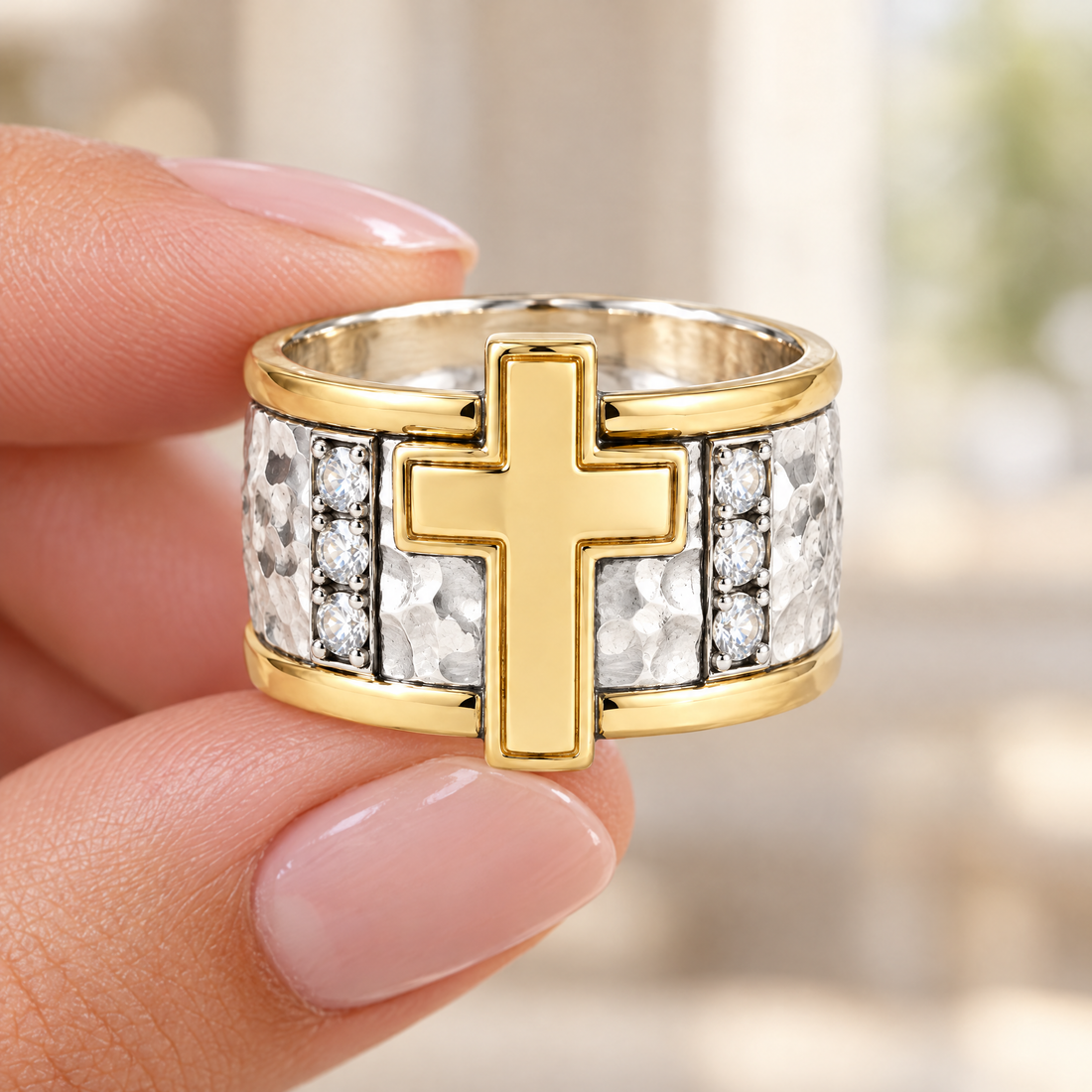 Cross Column Ring held in fingertips