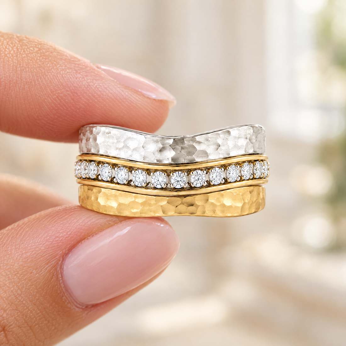 Hammered Wave Stack Ring held in fingertips