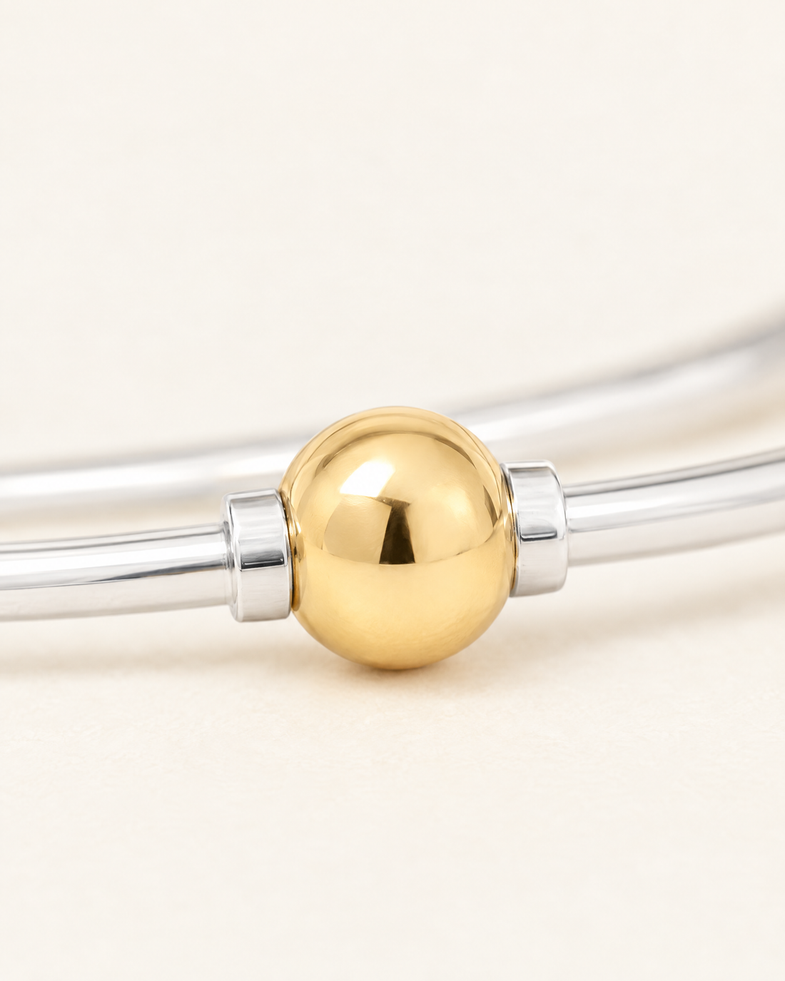 Coastal Ball Bracelet, close-up of the 14k gold filled ball and sterling silver collars