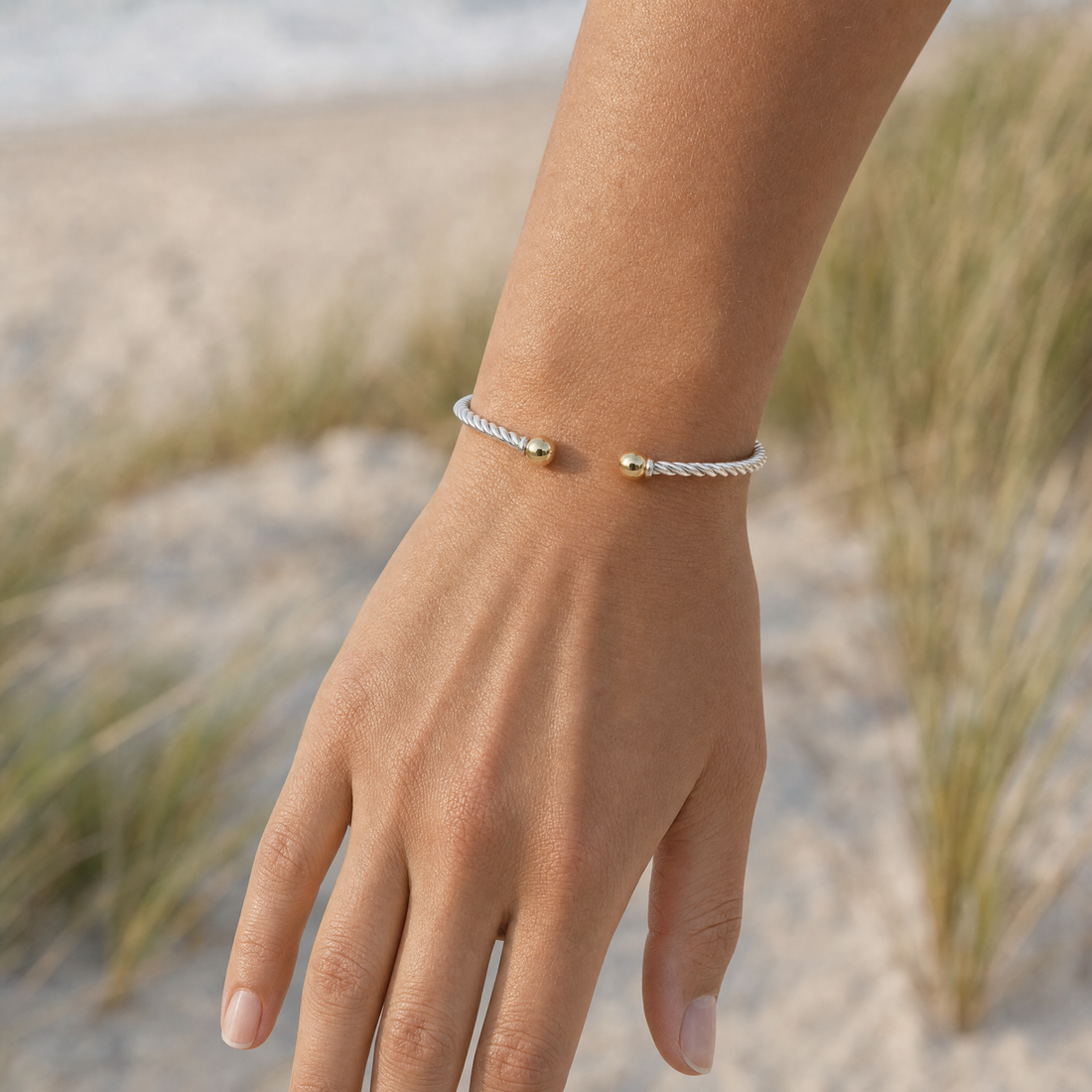 Seabrook Twist Cuff Bracelet in Sterling Silver with 14k Gold Filled Ball Ends, worn by a model, Ideaure photo